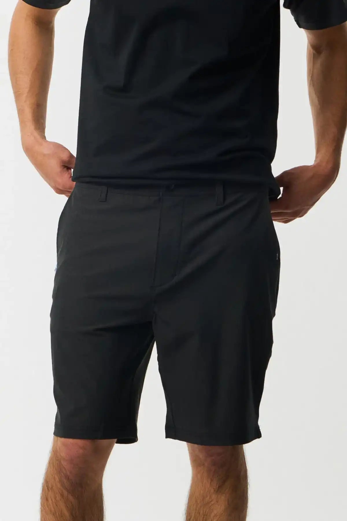 Person wearing black shorts and a black shirt on a white background