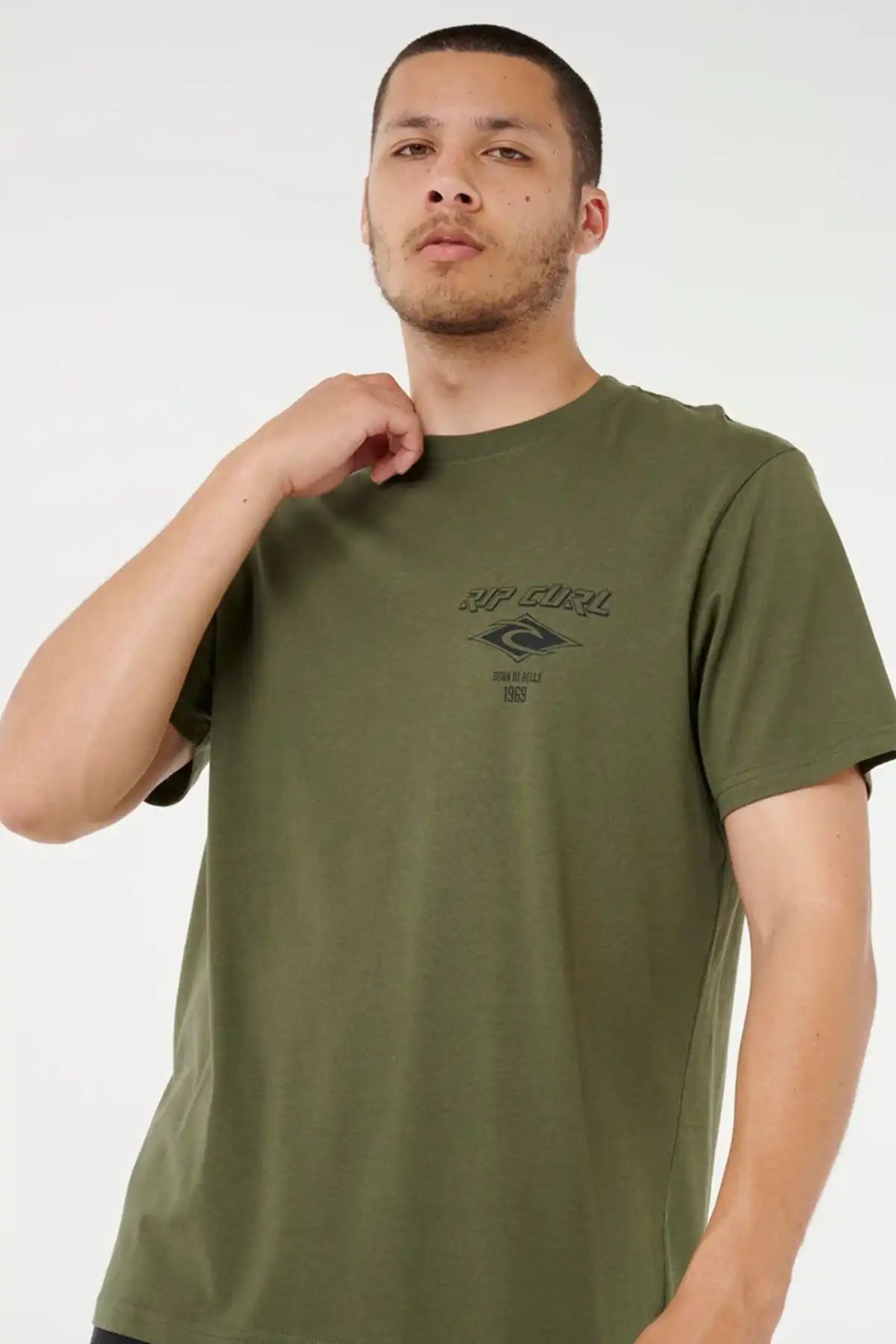 Man wearing a green t-shirt with a Rip Curl logo on a white background