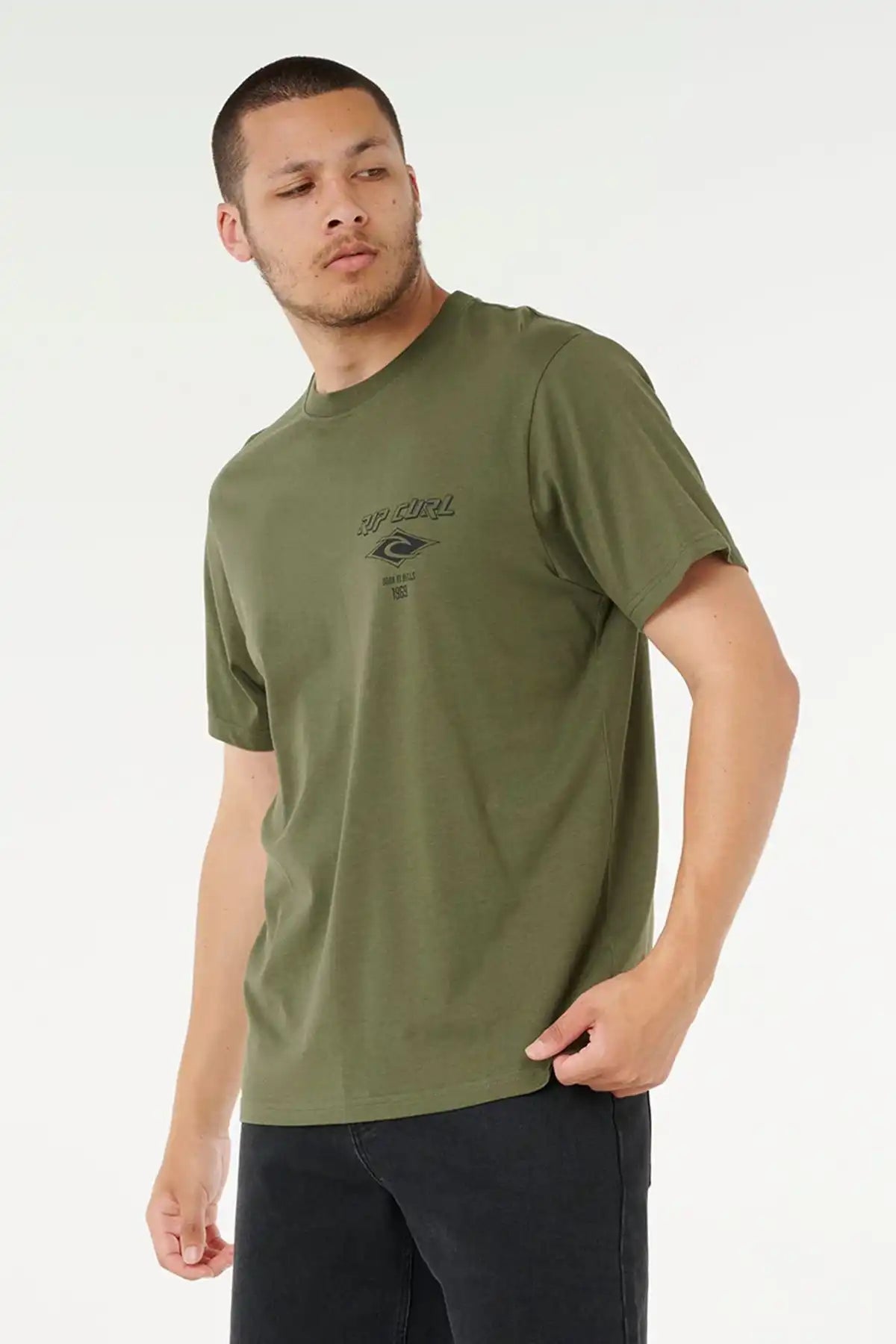 Man wearing an olive green t-shirt with a rip curl logo on a white background