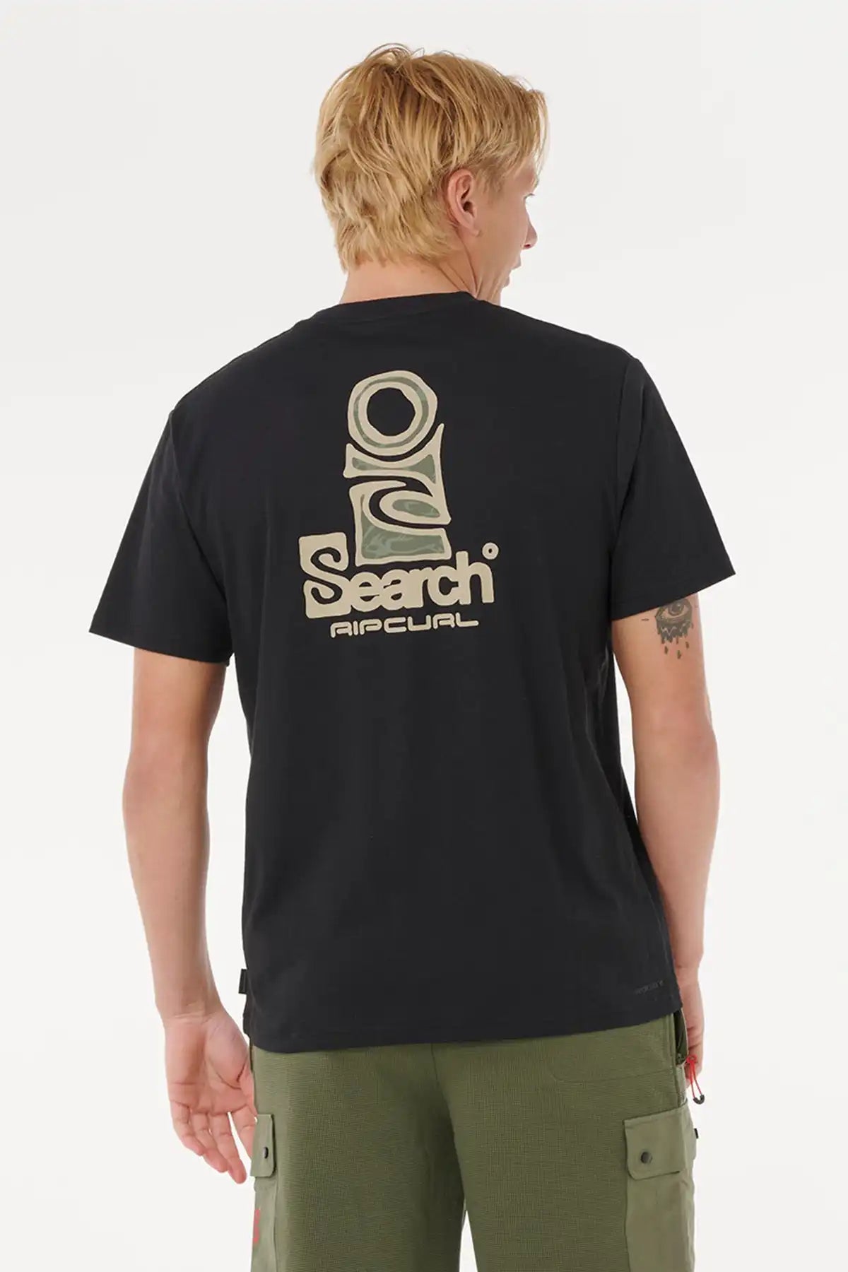 Person wearing a black t-shirt with a logo on the back, standing against a white background