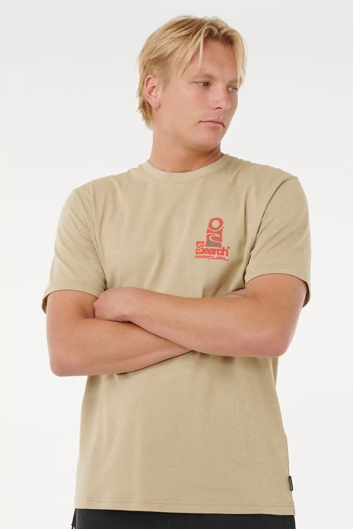 man with arms crossed and wearing a rock coloured shirt. 