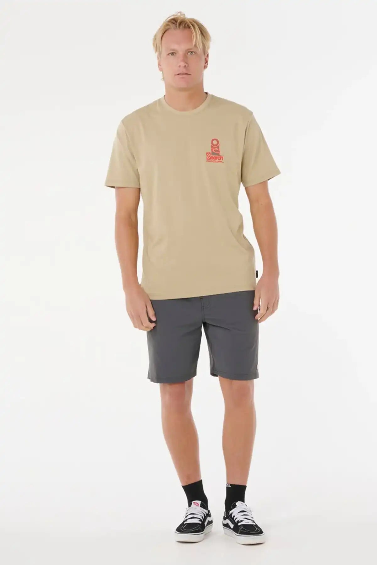 man wearing a Rock coloured t-shirt and grey shorts with Rip Curl Branding