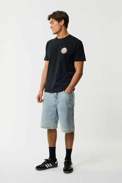 Person wearing a black t-shirt with a Rip Curl Wettie logo and light blue shorts on a white background
