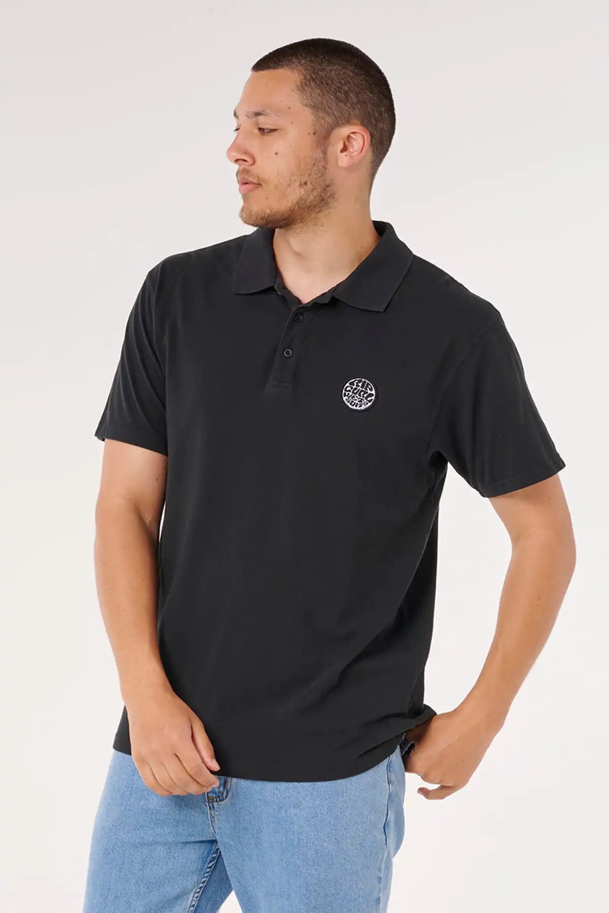Man wearing a black polo shirt with a Rip Curl logo on a white background