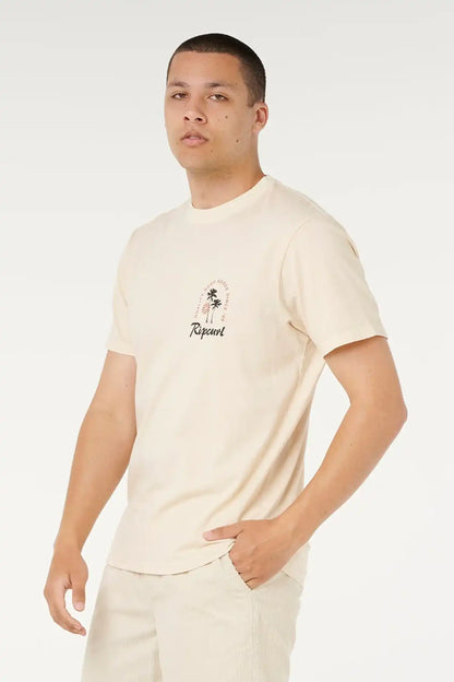 Man wearing a beige t-shirt with a logo on a white background