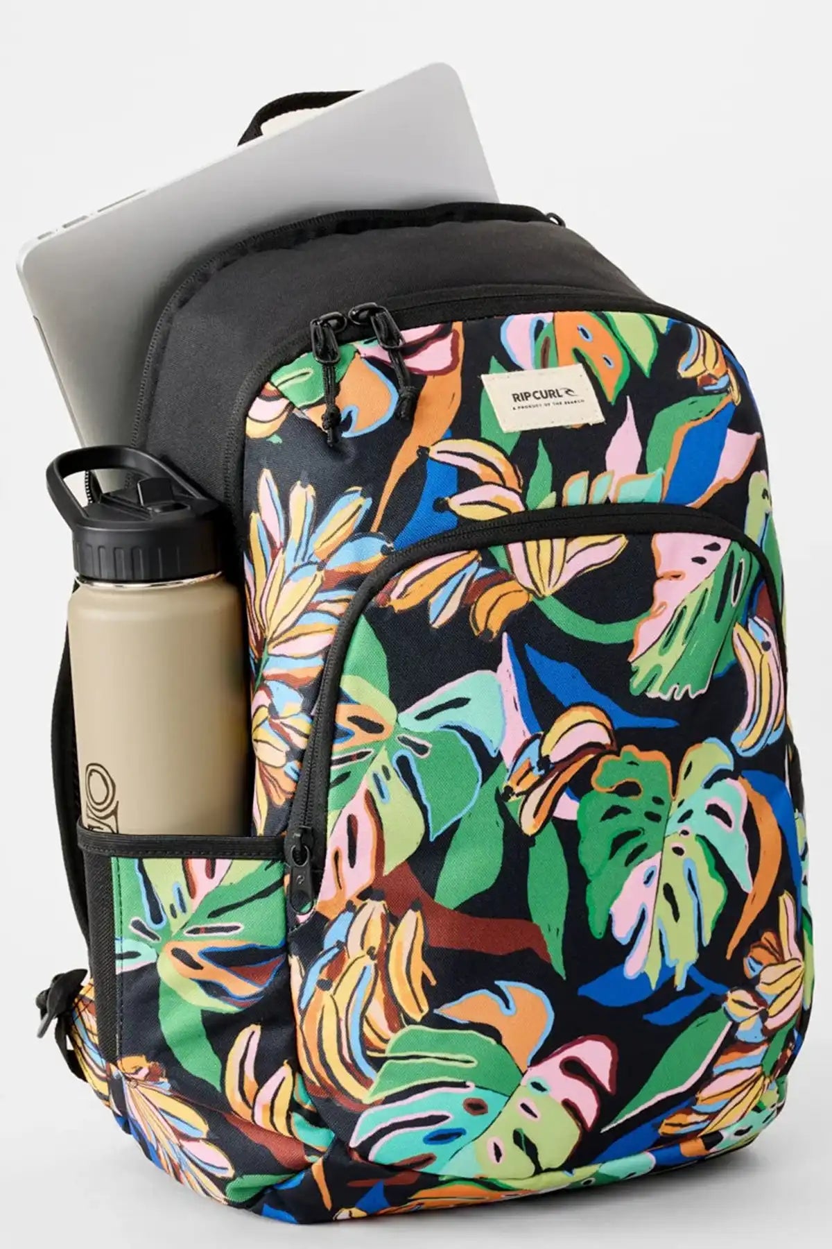 Backpack with colorful leaf pattern with laptop and drinkbottle showing out of the pockets on a white background