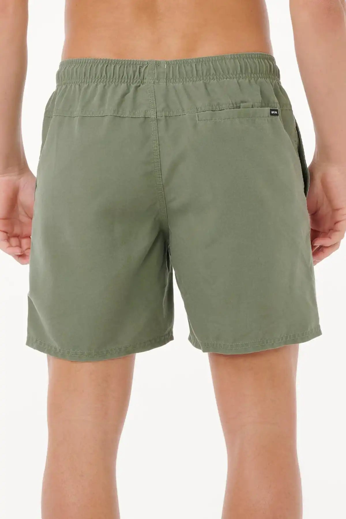 Green shorts worn by a person on a white background