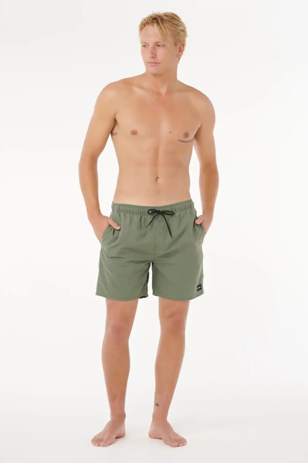 Man wearing green Rip Curl shorts on a white background