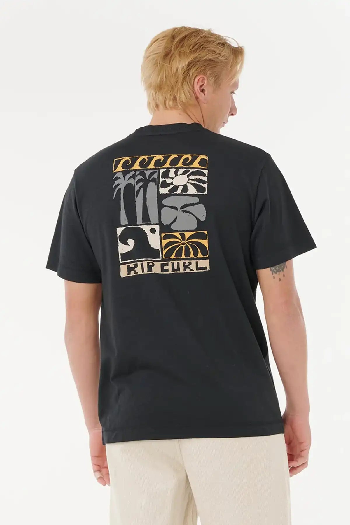 Person wearing a black Rip Curl t-shirt with a colorful graphic on the back against a white background