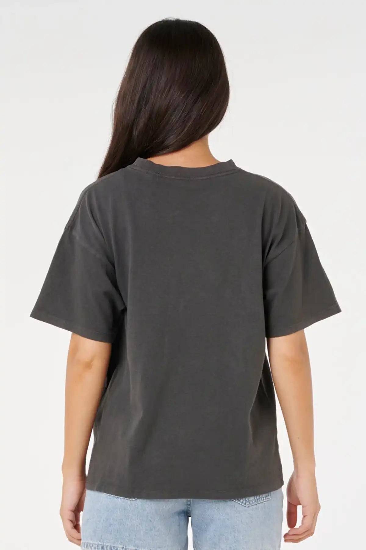 Person wearing a washed black t-shirt on a white background