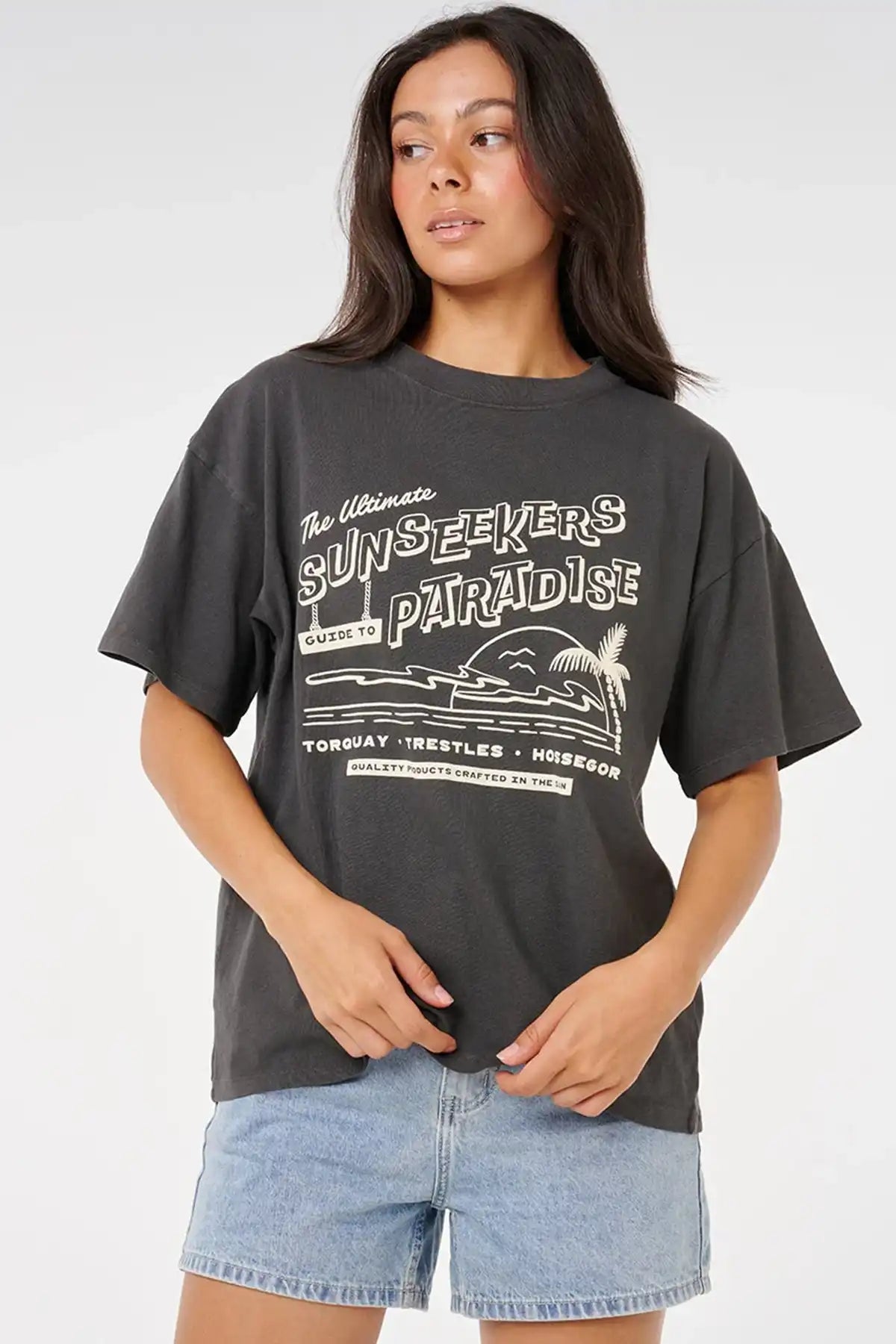 Person wearing a black t-shirt with white text and graphics on a plain background