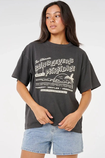 Person wearing a black t-shirt with white text and graphics on a plain background