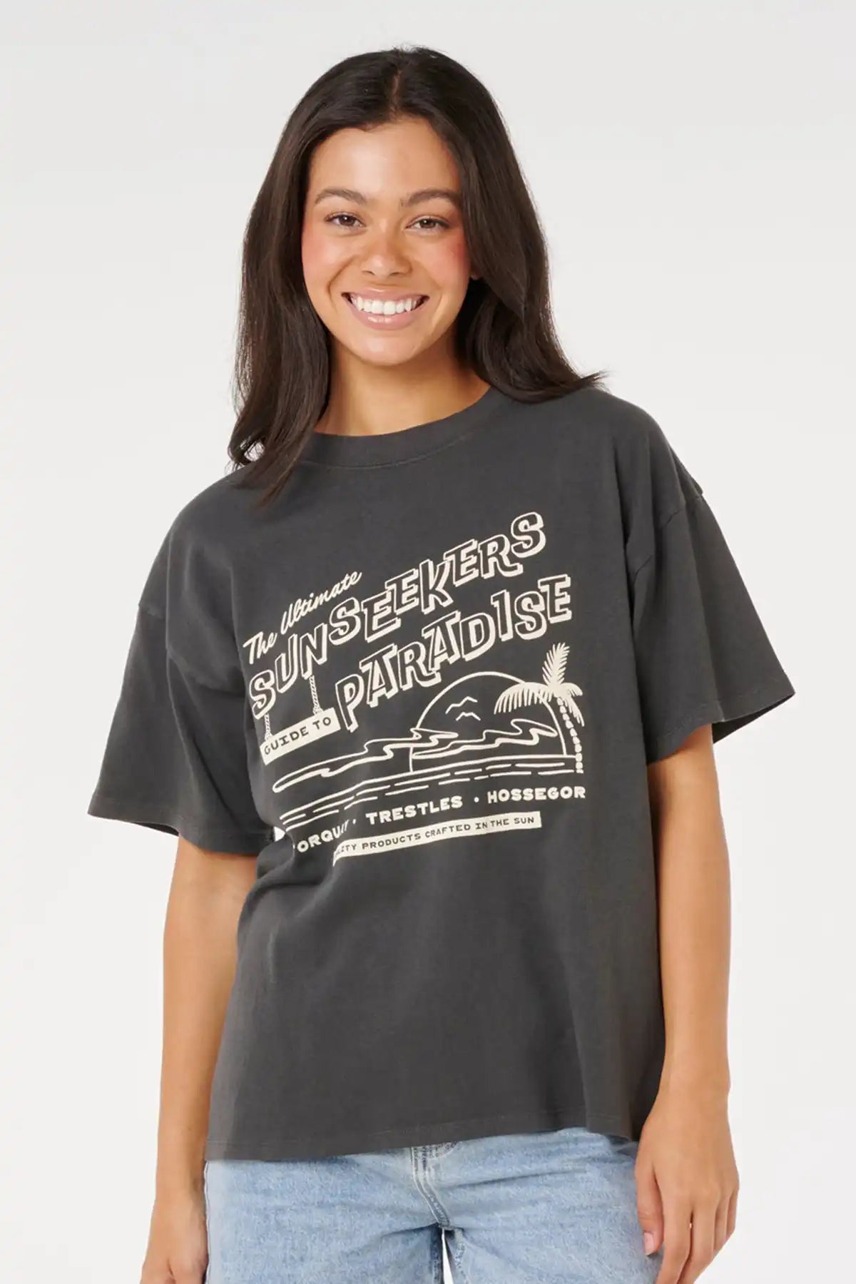 Woman wearing a dark gray t-shirt with a graphic design on a white background