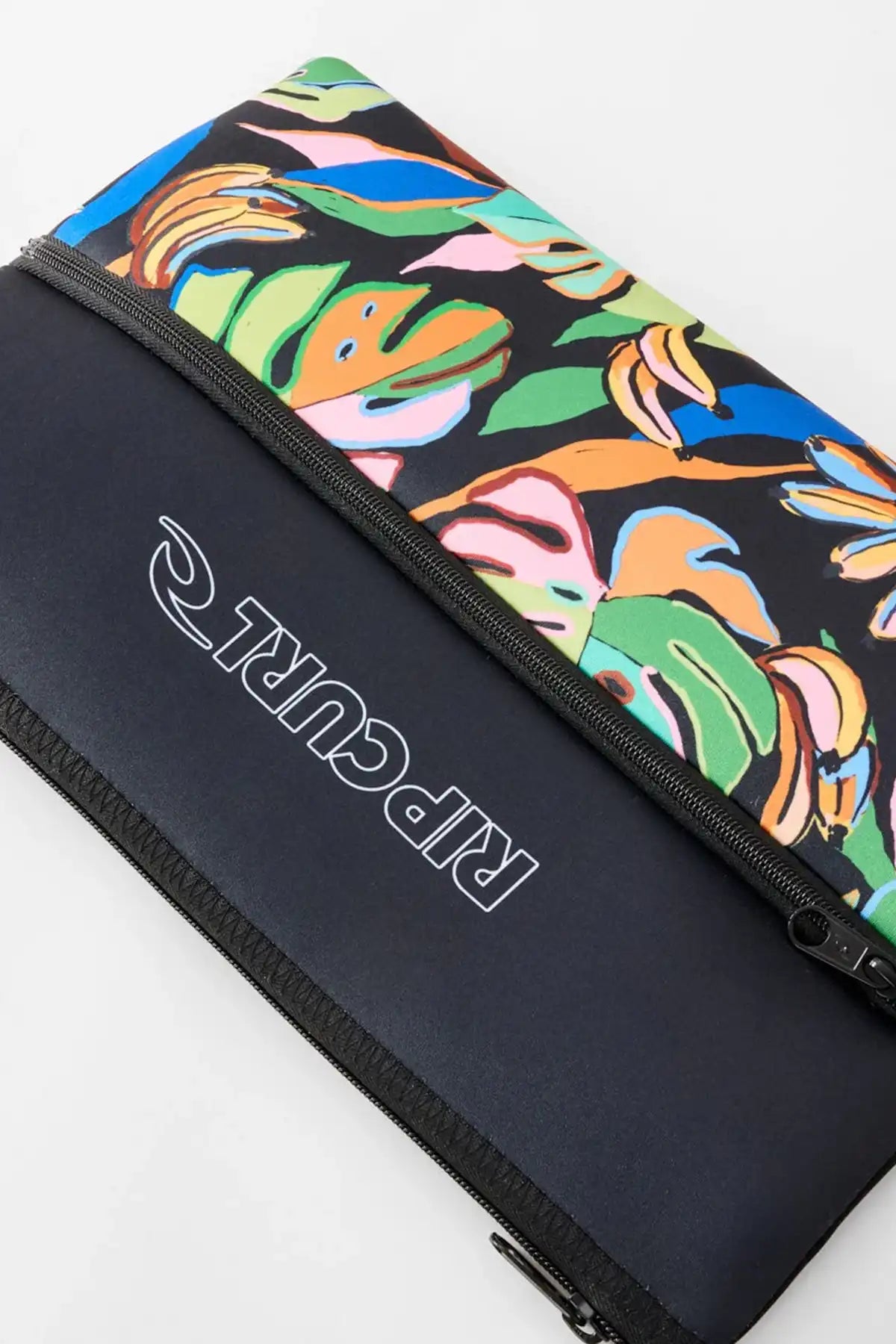 side view of Rip Curl branded pencil case with bright leaf pattern front