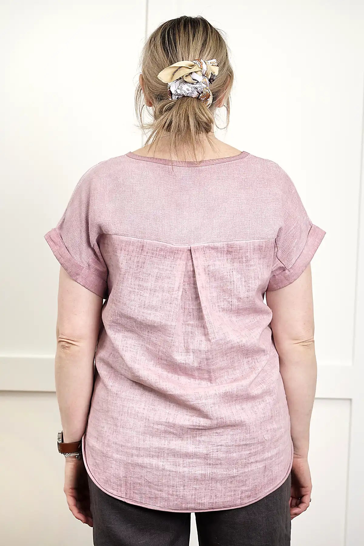 Person wearing a Rosa V Neck Linen Top in Pink from behind on a white background