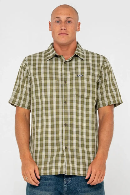 Man wearing a green checkered shirt with a Rusty logo on a white background