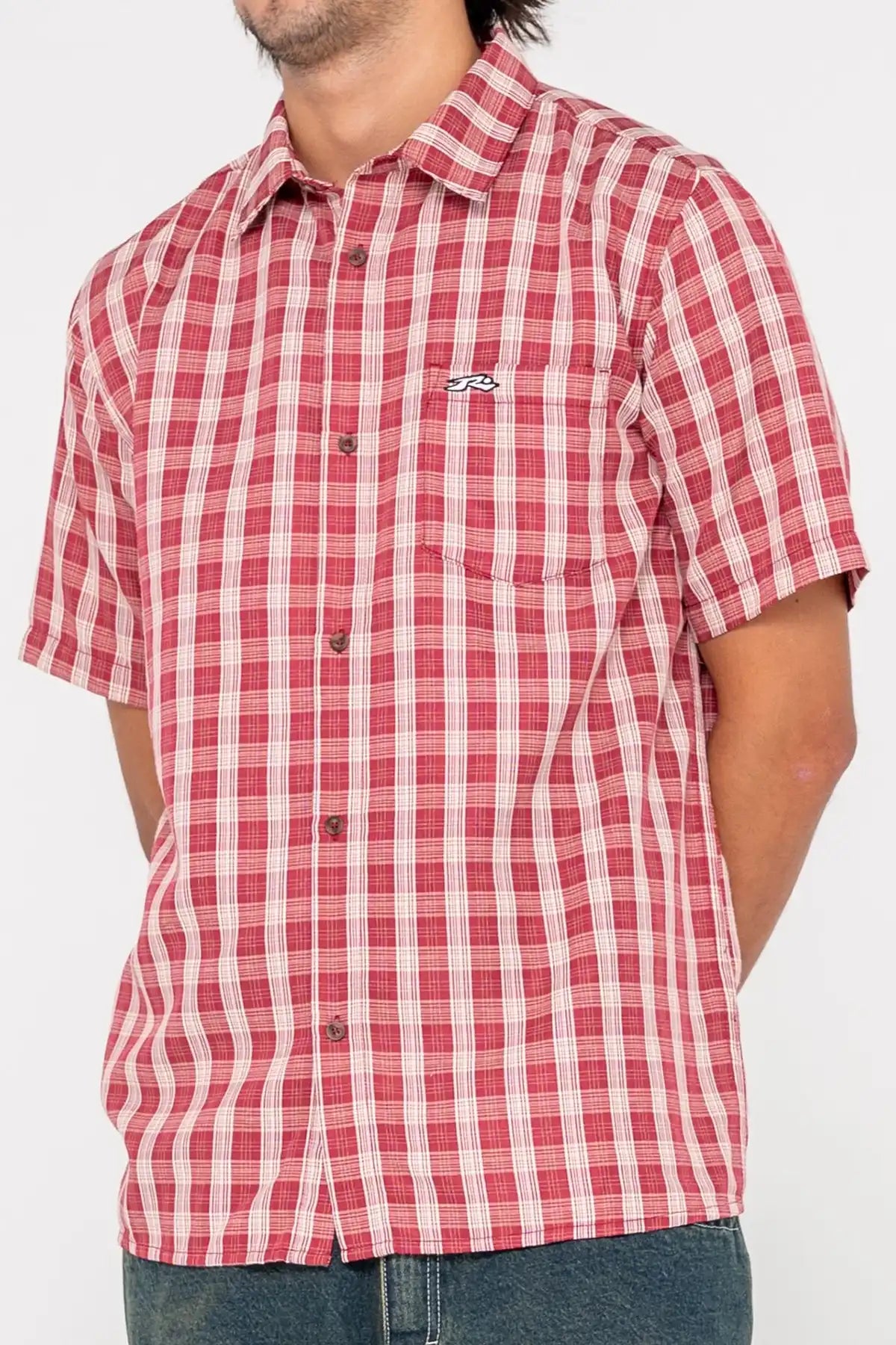 Red and white checkered shirt worn by a person on a white background
