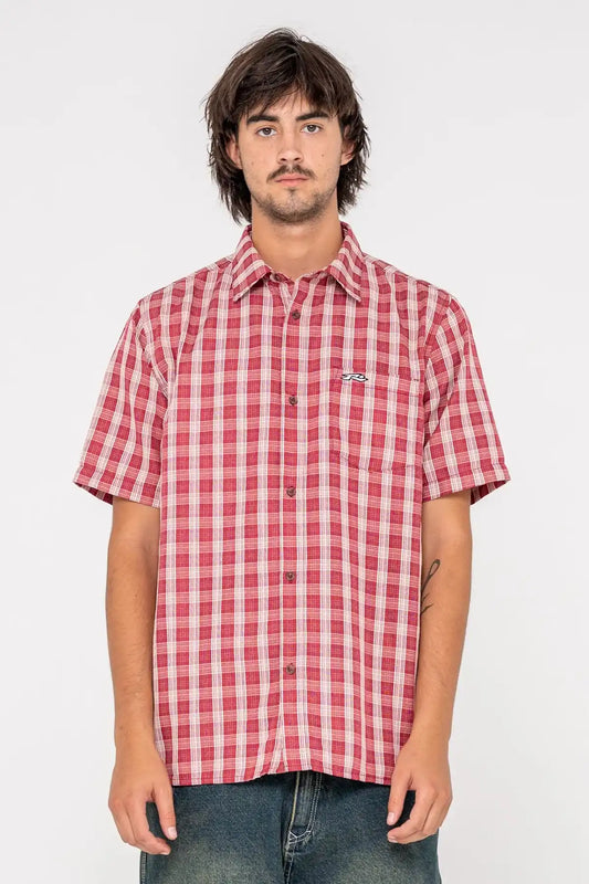 Person wearing a red and white checkered Rusty shirt on a white background