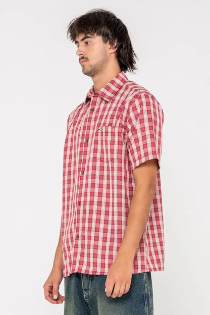 Man wearing a red and white Rusty checkered shirt on a white background