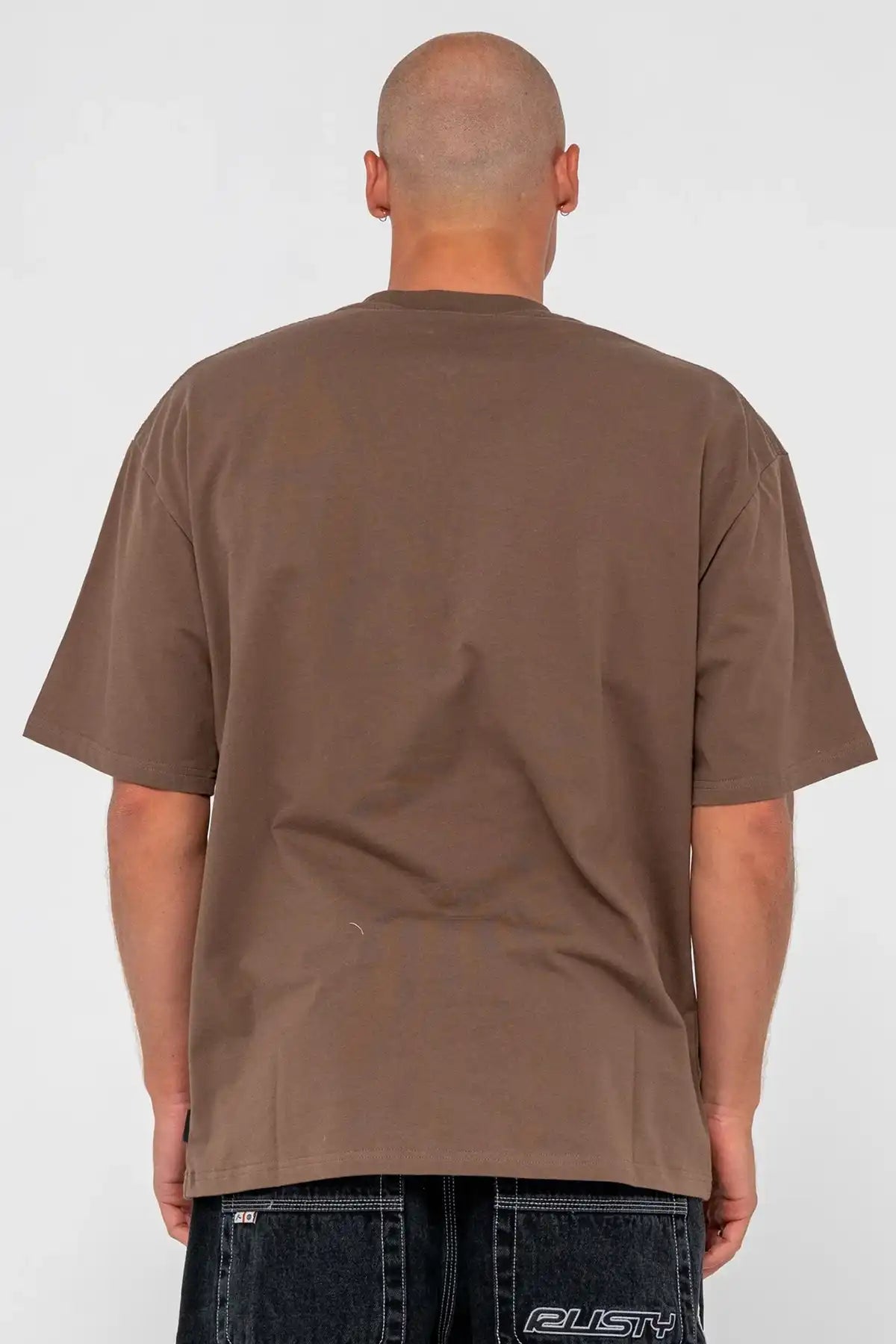 Person wearing a brown Rusty t-shirt on a white background