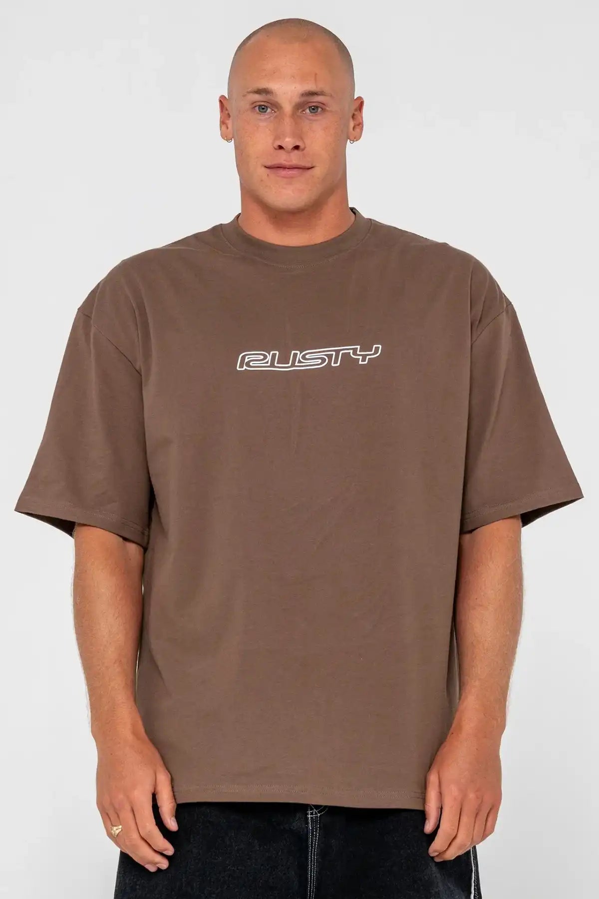 Man wearing a brown t-shirt with 'Rusty' logo on a white background