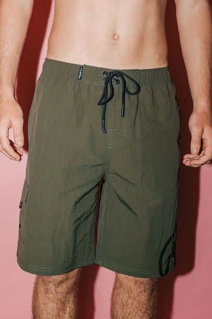 man wearing Rusty Mens BoardShort Peek Show Hybrid Waist in Army Green on white pink background front view