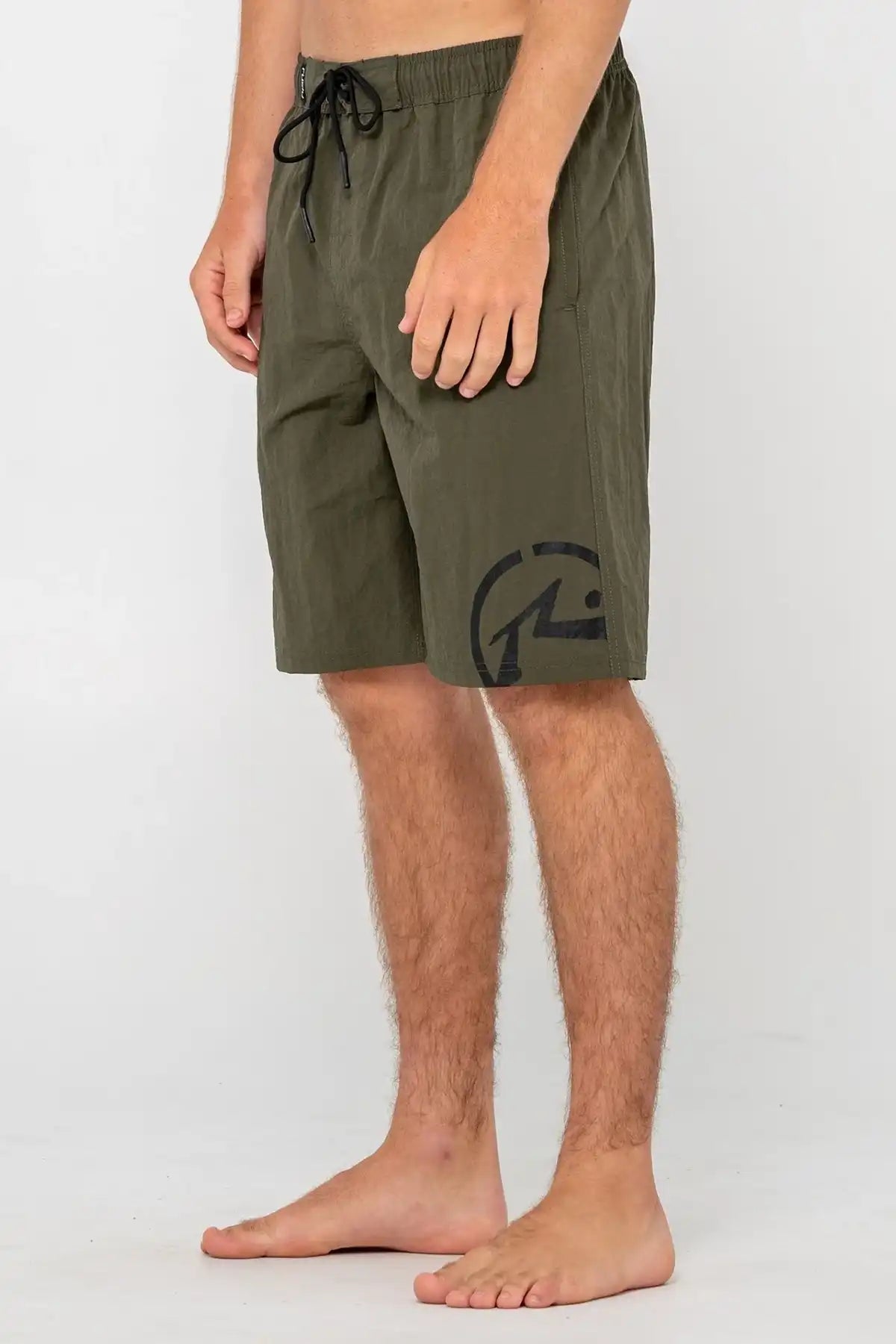 man wearing Rusty Mens BoardShort Peek Show Hybrid Waist in Army Green on white background side view