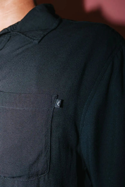 detailed view of the front pocket on the man wearing a black Rusty Mens Razor Blade Rayon Shirt