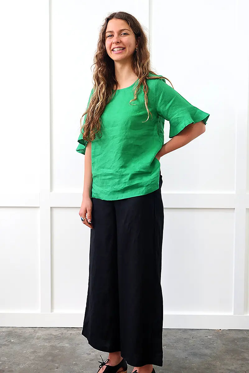 full model view of the See Saw Linen Flutter Sleeve Top in Emerald