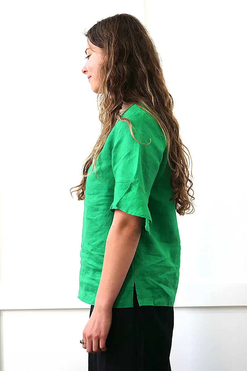 side view of the See Saw Linen Flutter Sleeve Top in Emerald