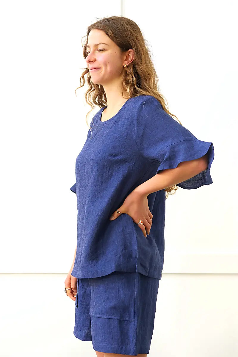 side view of the See Saw Linen Flutter Sleeve Top in Navy
