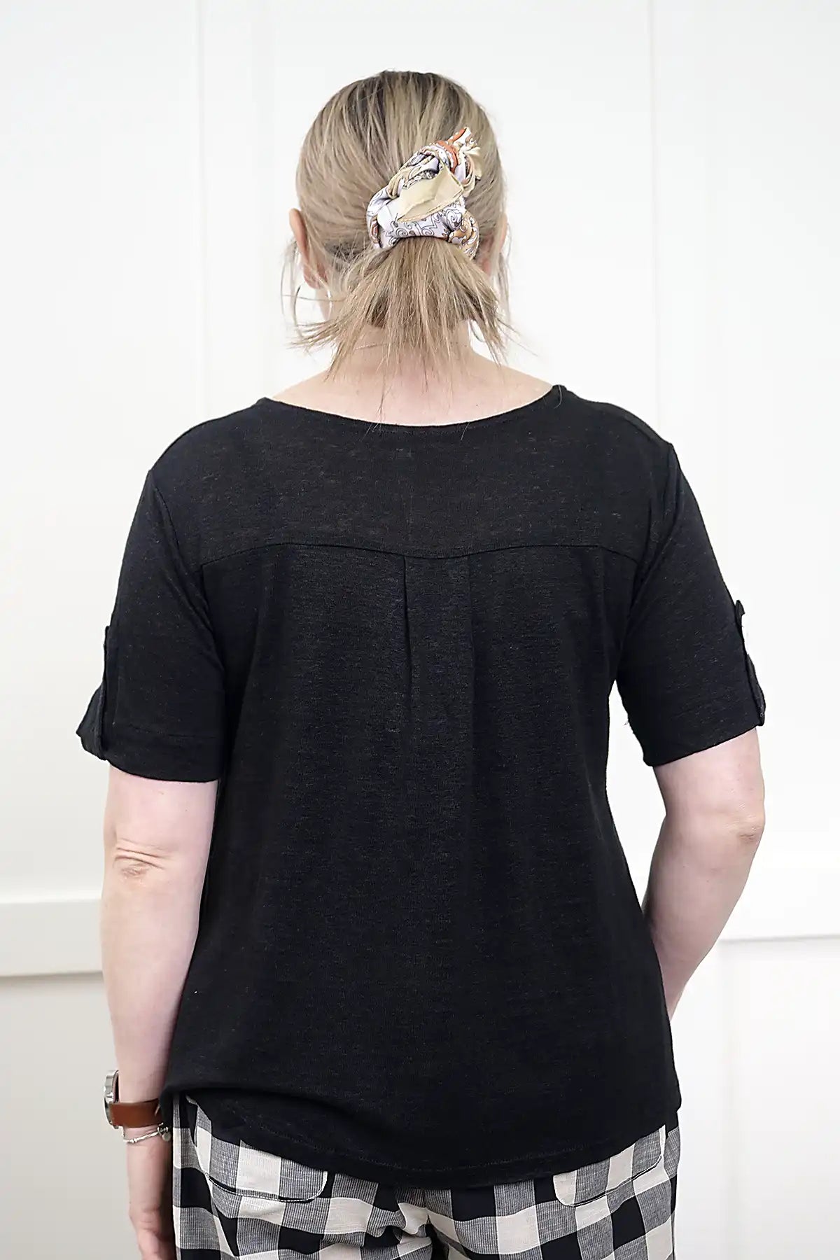 Person wearing a See Saw Linen Mixed Texture Top in Black from behind with a white background