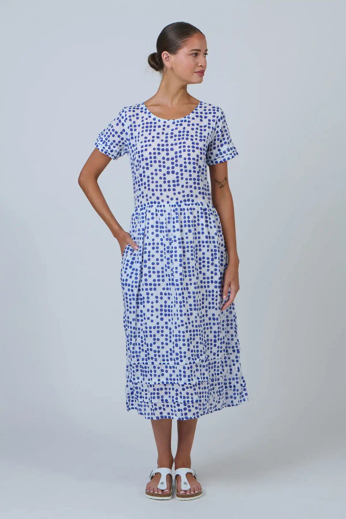 woman wearing a white dress with blue dot print front view