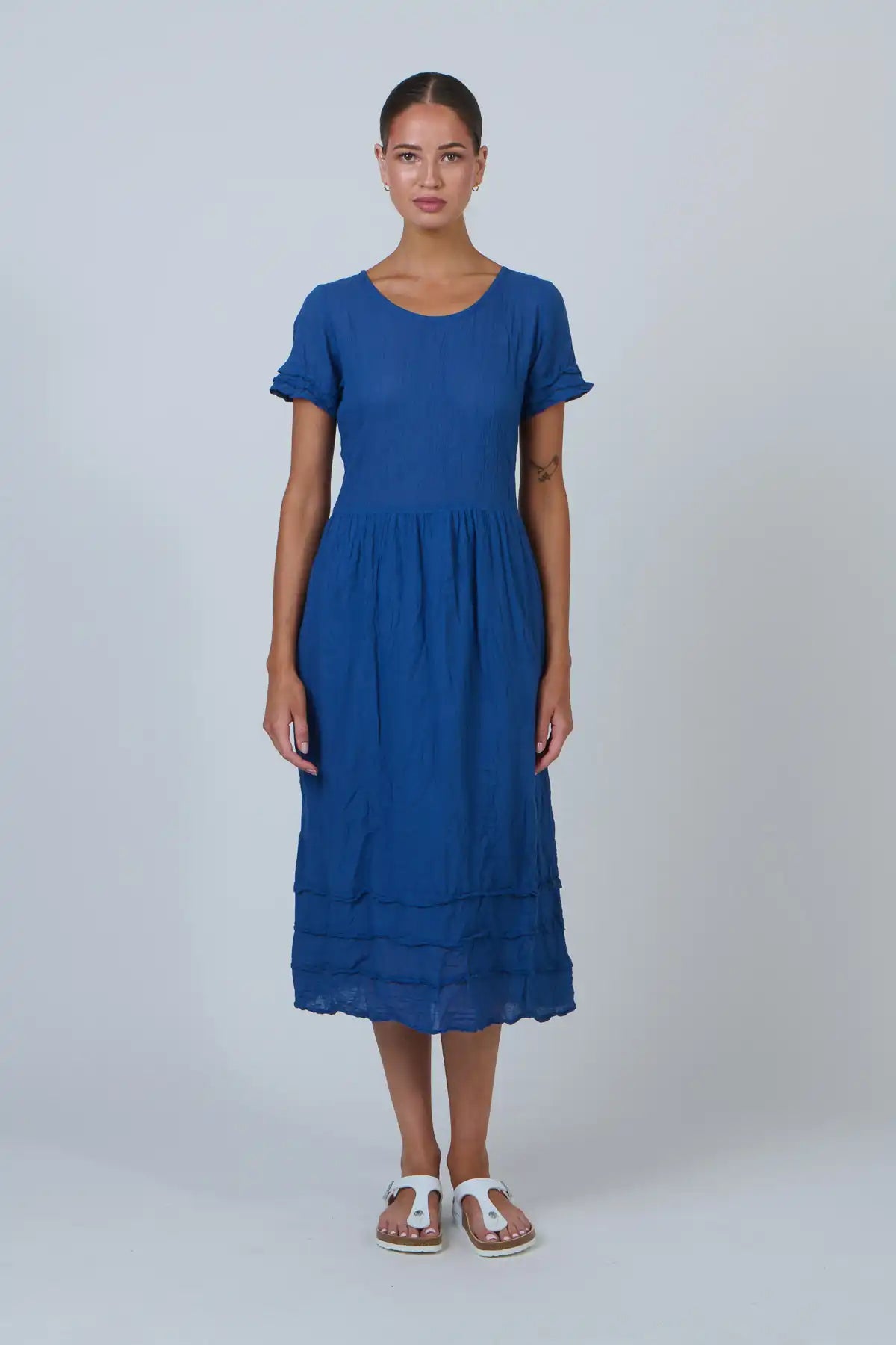 Woman wearing a blue dress on a white background