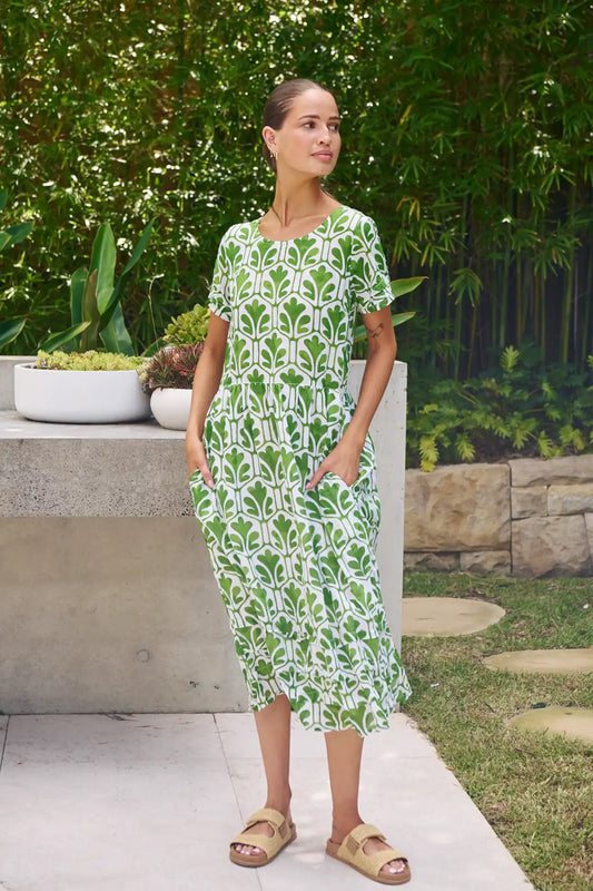 woman wearing the summer garden leaf print dress standing in the garden