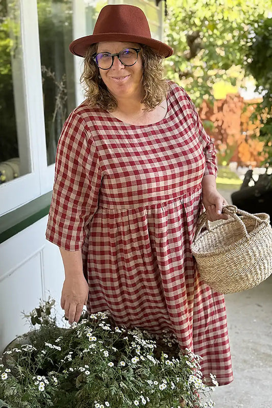 Rachille picking flowers in the Talia Soft Gingham Dress in Red and Beige