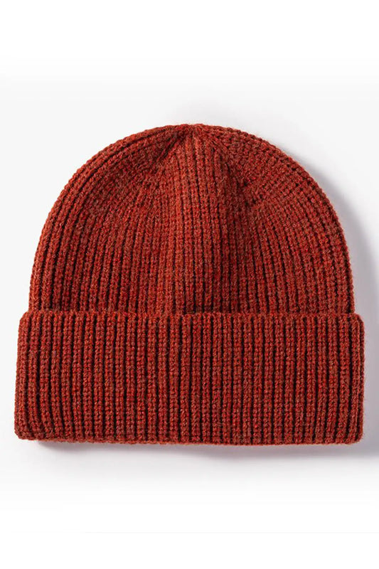 Red knit beanie on a white background