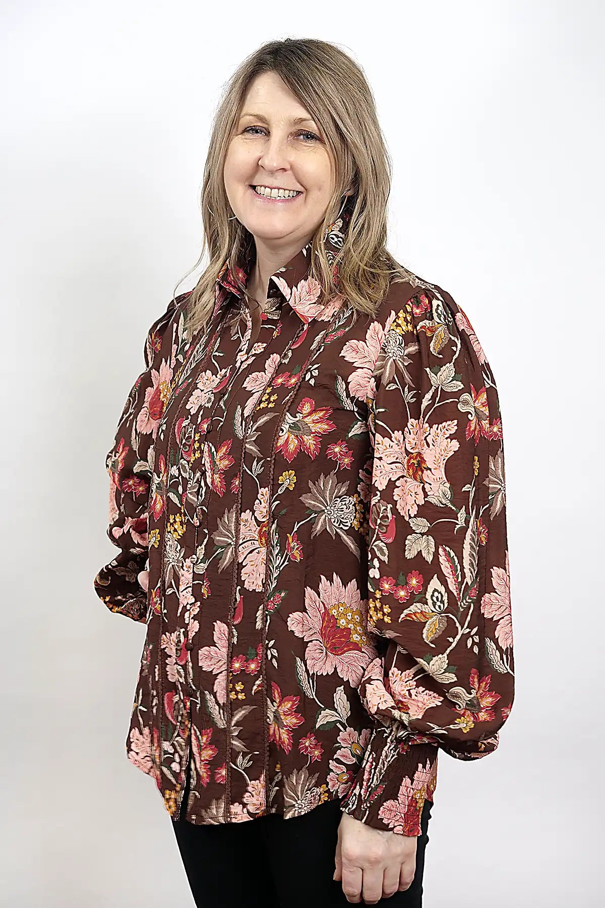 Woman wearing a Wildflower Lace Blouse in Chocolate on a white background, side view