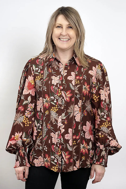 Woman wearing a Wildflower Lace Blouse in Chocolate against a white background