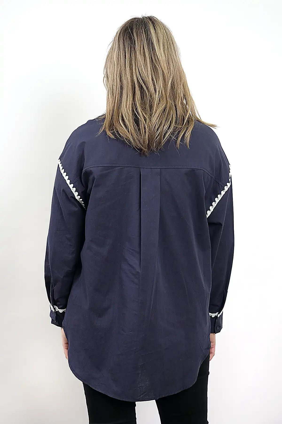 Person wearing the Wren Long Sleeve Shirtin Navy with white accents on a white background back view