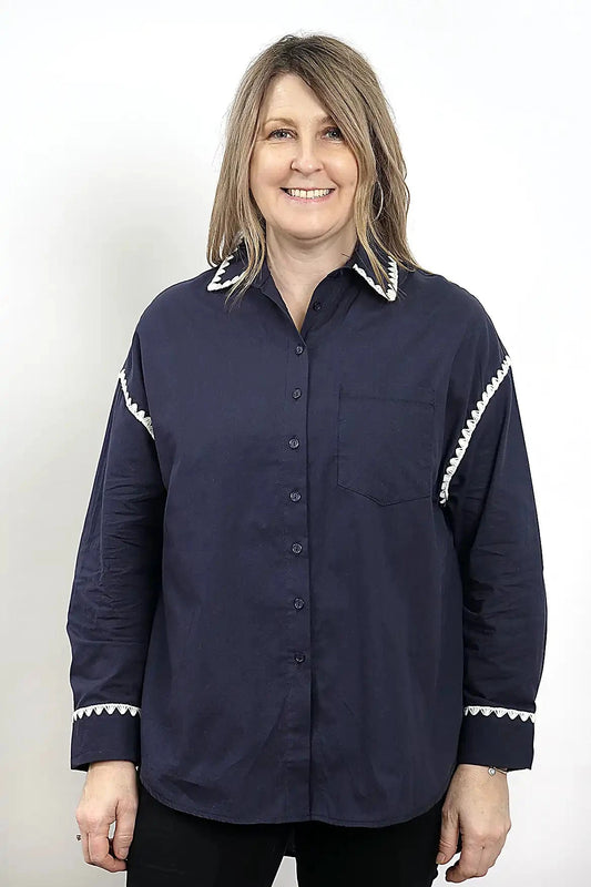 Woman wearing a the Wren Long Sleeve Shirtin Navy with white trim on a plain background