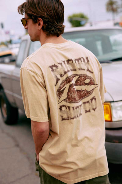 back view of model wearing the Rusty Mens S/S Tee Ole Faithful in Light Fennel