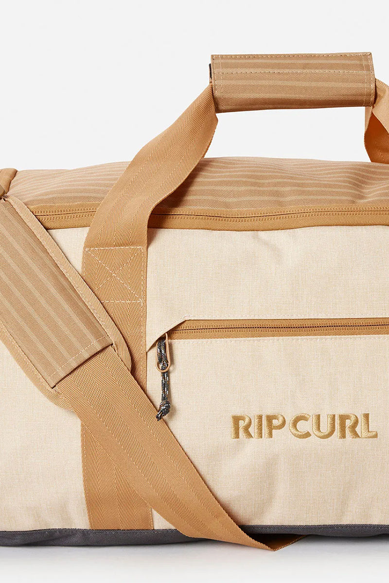 detailed side view of the Rip Curl Large Packable Duffle Bag 50L showing the embodied logo and zip pocket