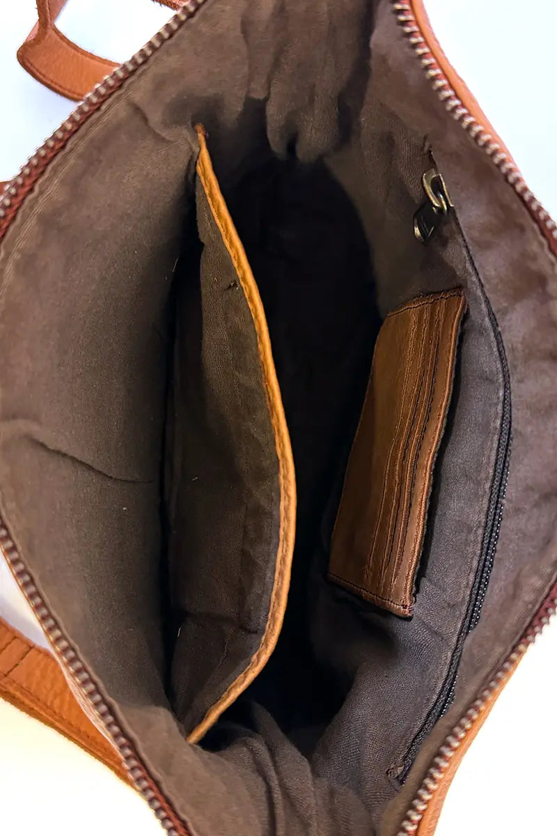 view showing zip compartment, card slots and phone pocket inside the Rugged Hide Jackie Cross body bag in Tan