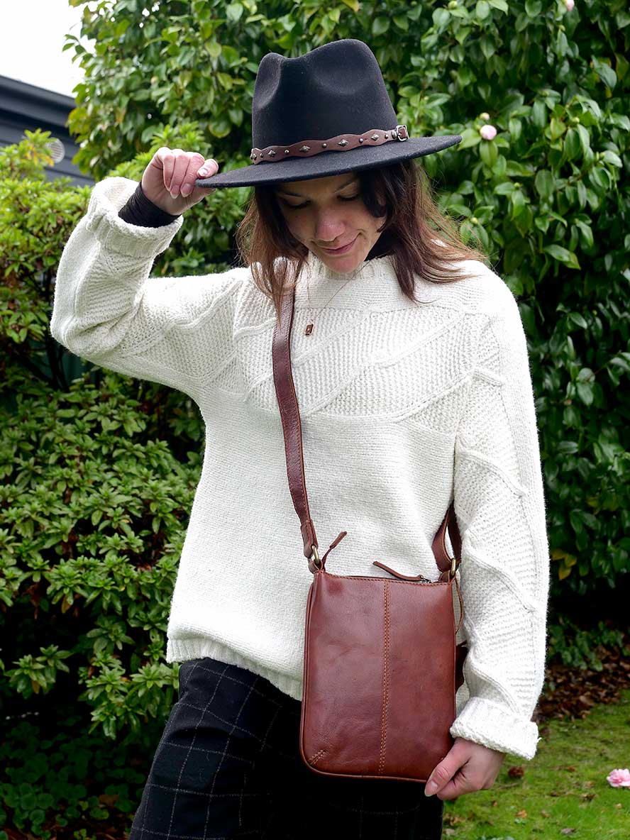 model wearing Oran Leather Cross Over Bag - Kimberly in Brandy