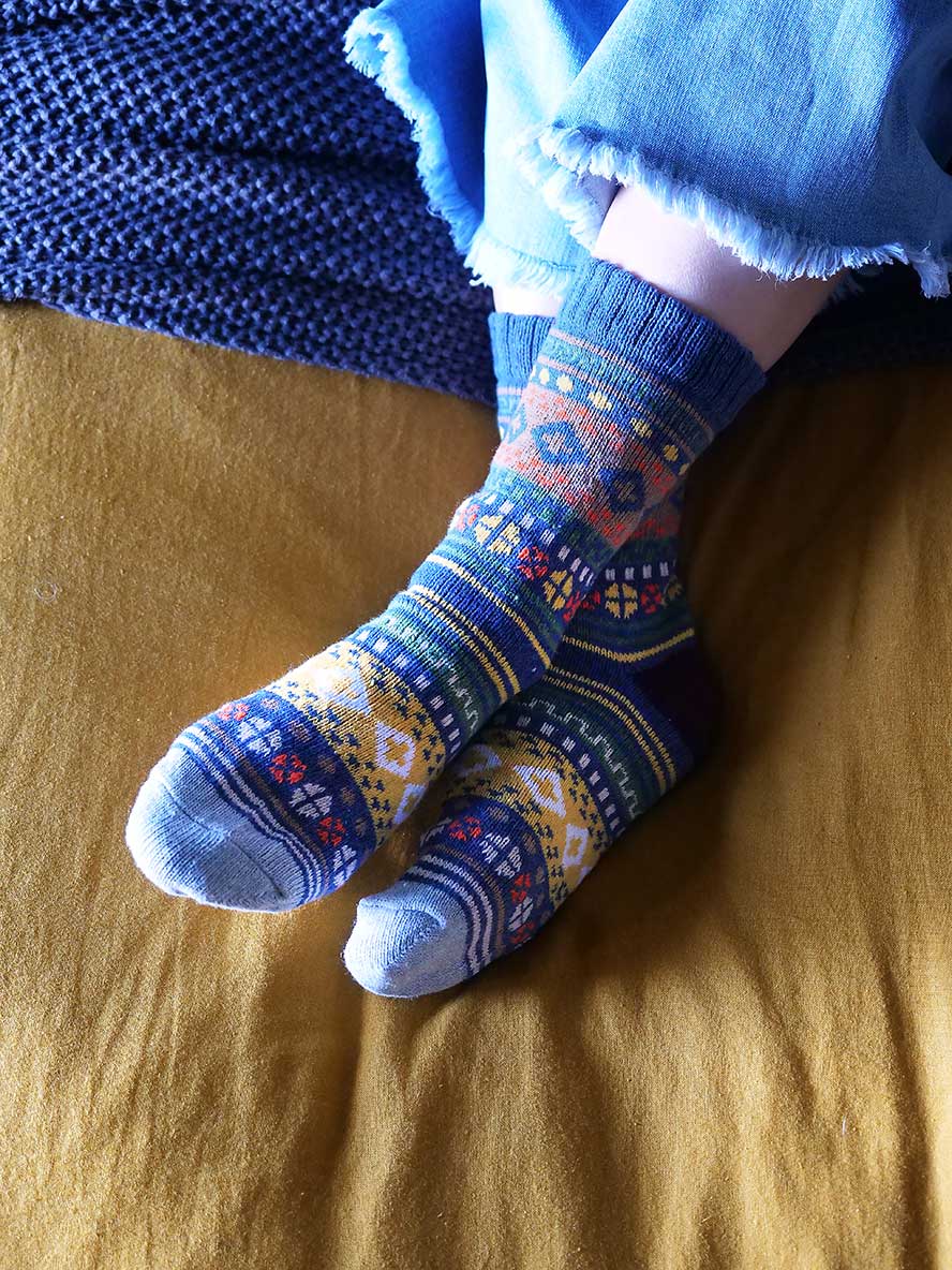 relaxing on the bed in the Nordic Style Socks in Blue