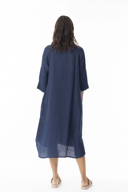 Woman wearing a Orientique Linen Solid Navy Shirt Dress from behind on a white background