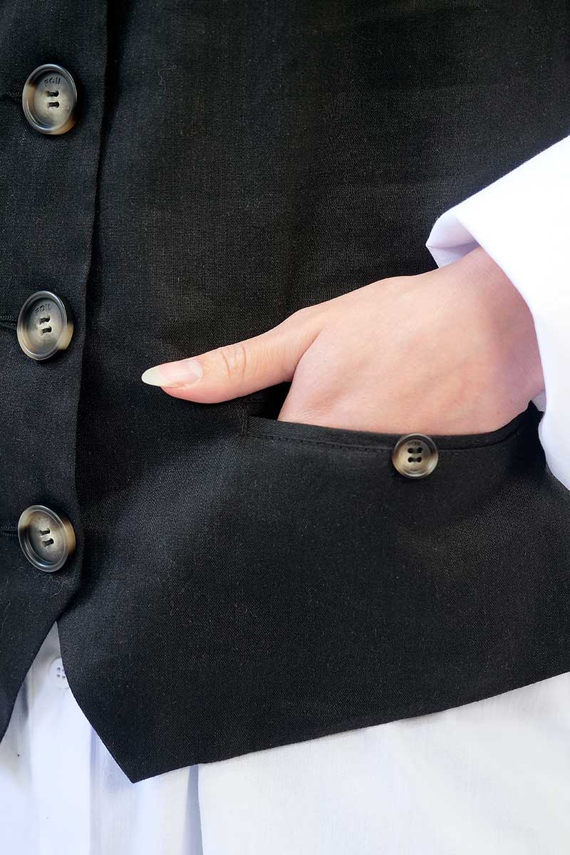 detailed view of the front pocket and buttons on the Foil Waisted Vest in Black