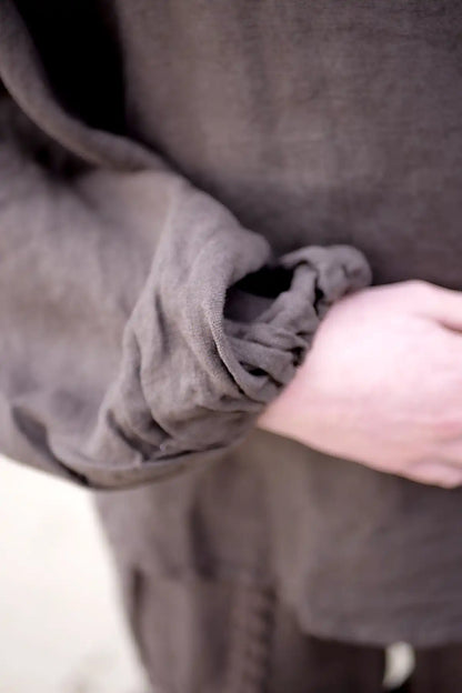 Close-up of a person wearing a brown garment with a visible seam.