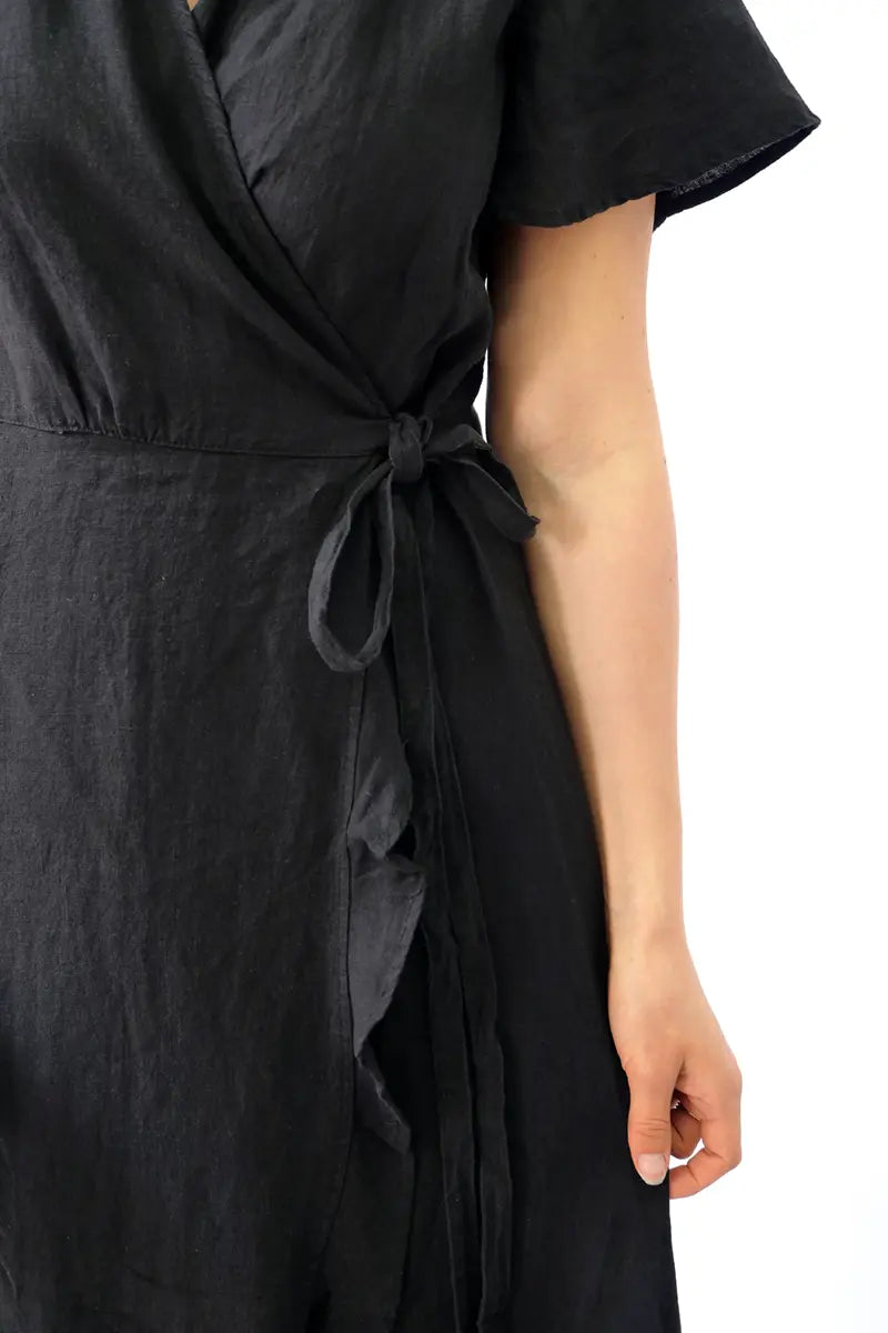 tie detail view of the Humidity  Kai Linen Wrap Dress in Black